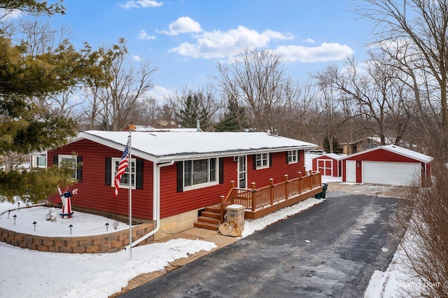 rustic home featuring a garage and an outbuilding