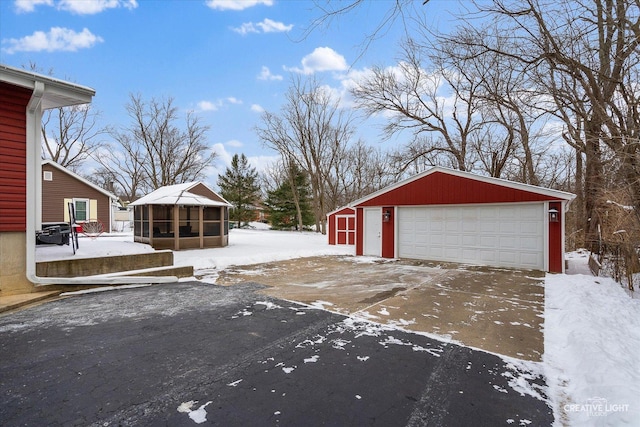 exterior space with a detached garage and an outdoor structure