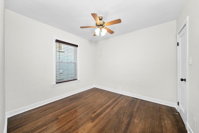 spare room featuring dark wood-type flooring and ceiling fan