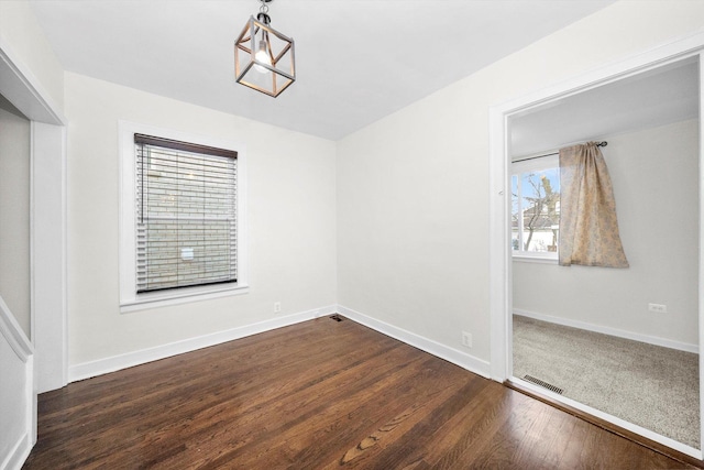 spare room with dark hardwood / wood-style floors