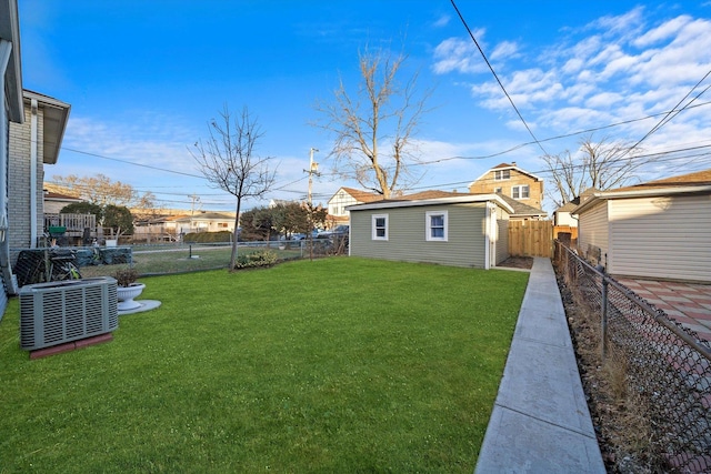 view of yard featuring an outbuilding and central AC unit