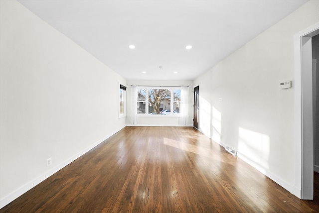 unfurnished room with hardwood / wood-style flooring