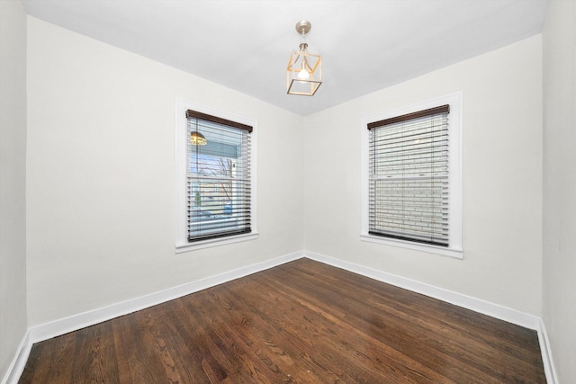 spare room featuring dark hardwood / wood-style floors