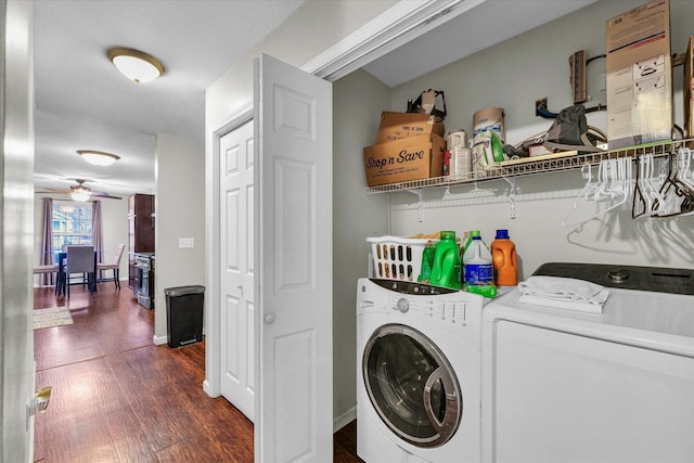 laundry area featuring ceiling fan, washing machine and clothes dryer, and dark hardwood / wood-style flooring