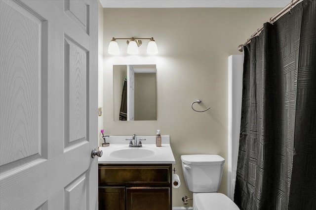 bathroom with walk in shower, vanity, and toilet