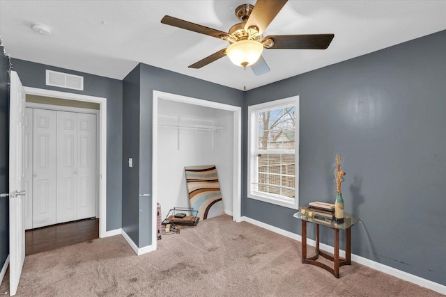 interior space featuring ceiling fan and carpet floors