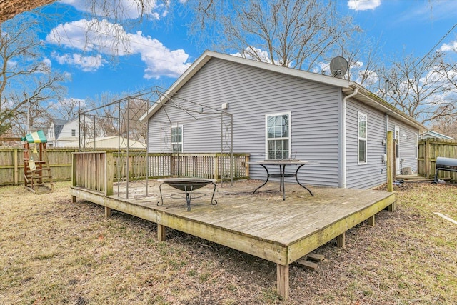 rear view of house featuring a wooden deck