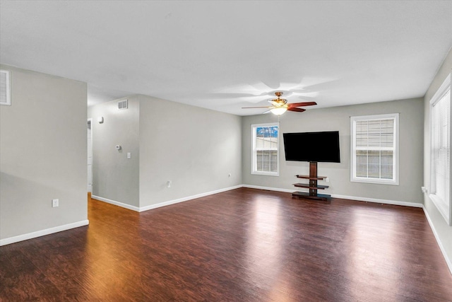 unfurnished living room with dark hardwood / wood-style flooring and ceiling fan