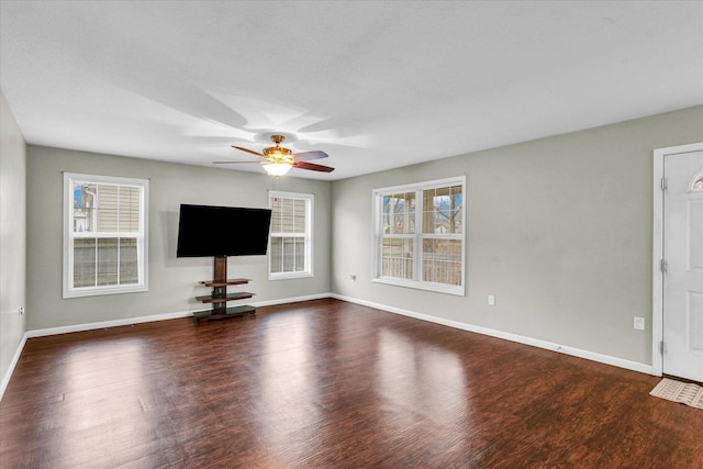 unfurnished living room featuring dark hardwood / wood-style flooring and ceiling fan