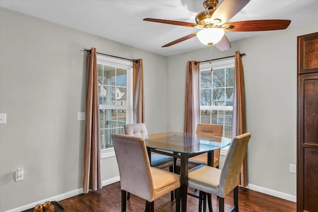 dining area with ceiling fan and dark hardwood / wood-style flooring