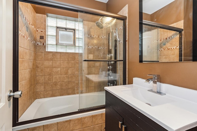 bathroom featuring enclosed tub / shower combo and vanity