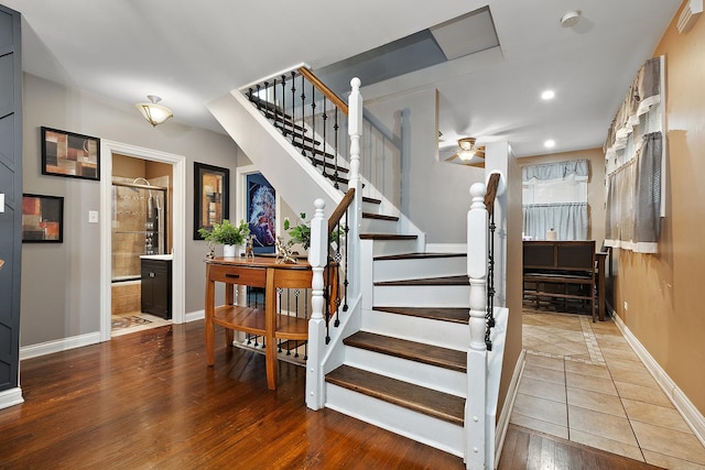 stairway with hardwood / wood-style flooring