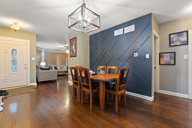 dining room featuring ceiling fan with notable chandelier and dark hardwood / wood-style floors