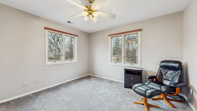 living area with ceiling fan and carpet floors