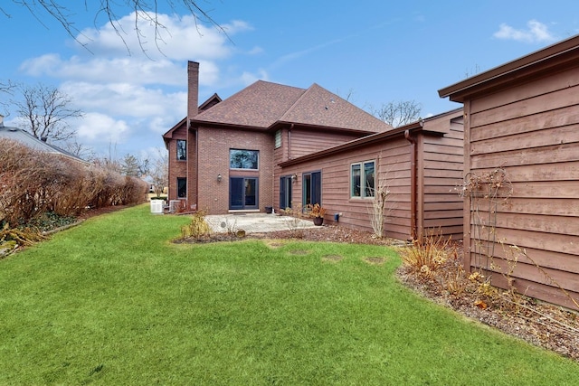 back of house featuring a yard and a patio