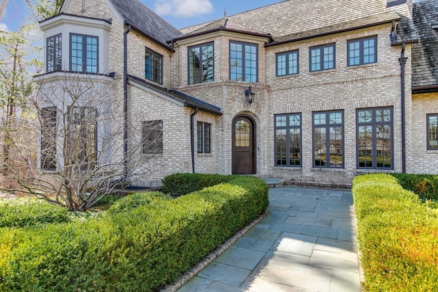 french country home featuring a patio area