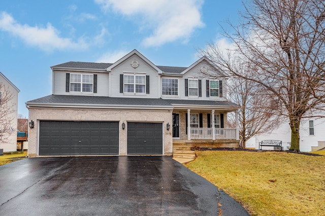 traditional home featuring a garage, brick siding, aphalt driveway, a porch, and a front yard