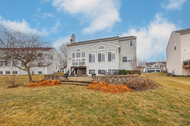 back of property with a yard, a chimney, a patio, and central air condition unit