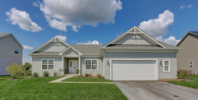 craftsman-style house featuring a garage and a front lawn