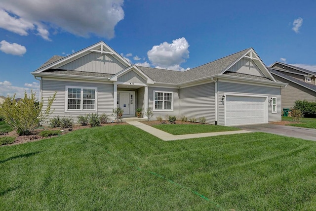 craftsman house featuring a garage and a front lawn