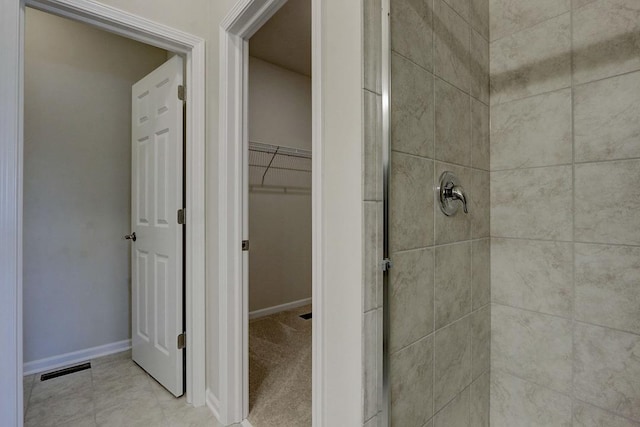 bathroom with tiled shower