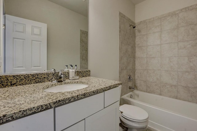 full bathroom with vanity, toilet, and tiled shower / bath