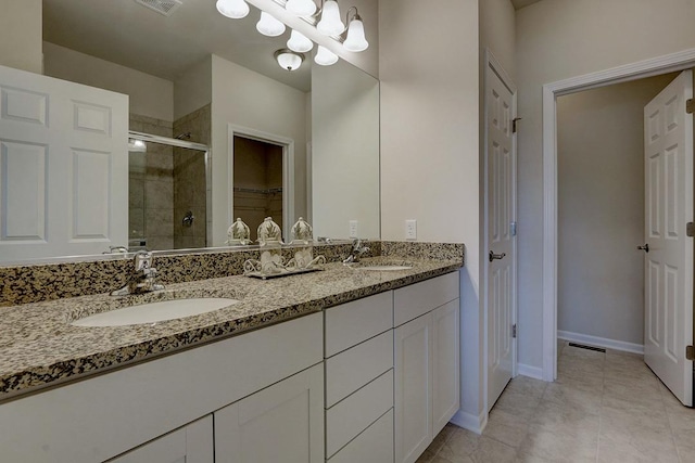 bathroom featuring vanity, tile patterned flooring, a chandelier, and walk in shower