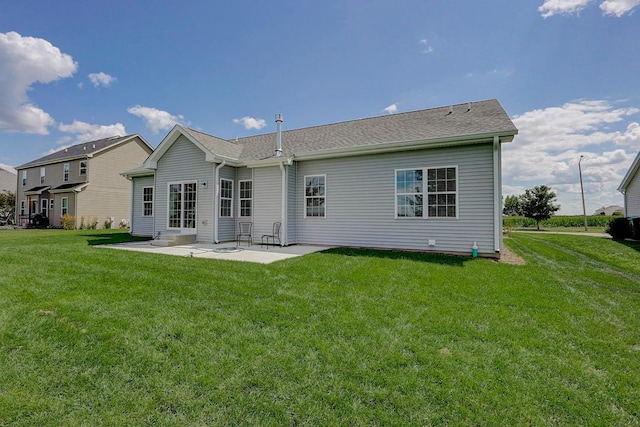 rear view of property featuring a patio area and a lawn