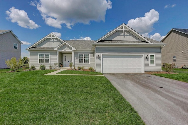 craftsman house featuring a garage and a front yard