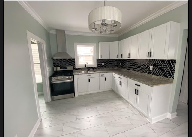 kitchen with stainless steel range with gas cooktop, sink, white cabinets, and wall chimney exhaust hood