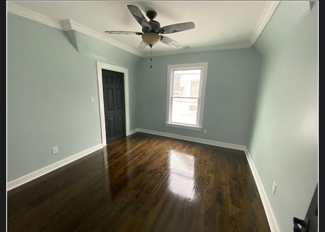 spare room featuring crown molding, dark hardwood / wood-style floors, and ceiling fan