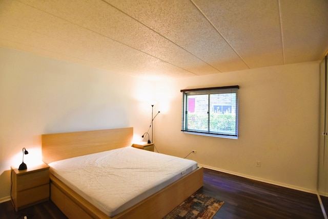 bedroom featuring dark wood-type flooring