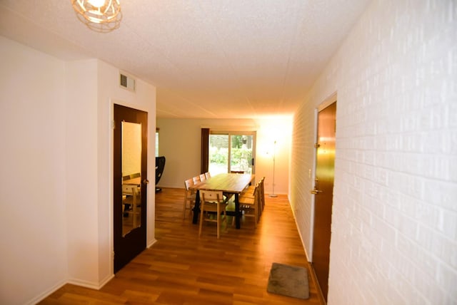 corridor with hardwood / wood-style floors