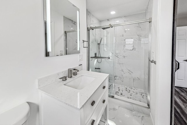 bathroom with vanity and a shower with shower door