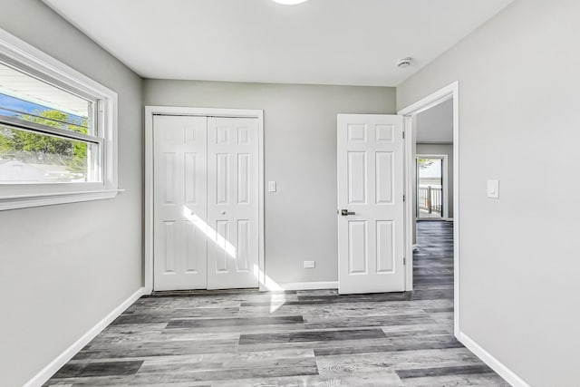 unfurnished bedroom featuring hardwood / wood-style floors and a closet