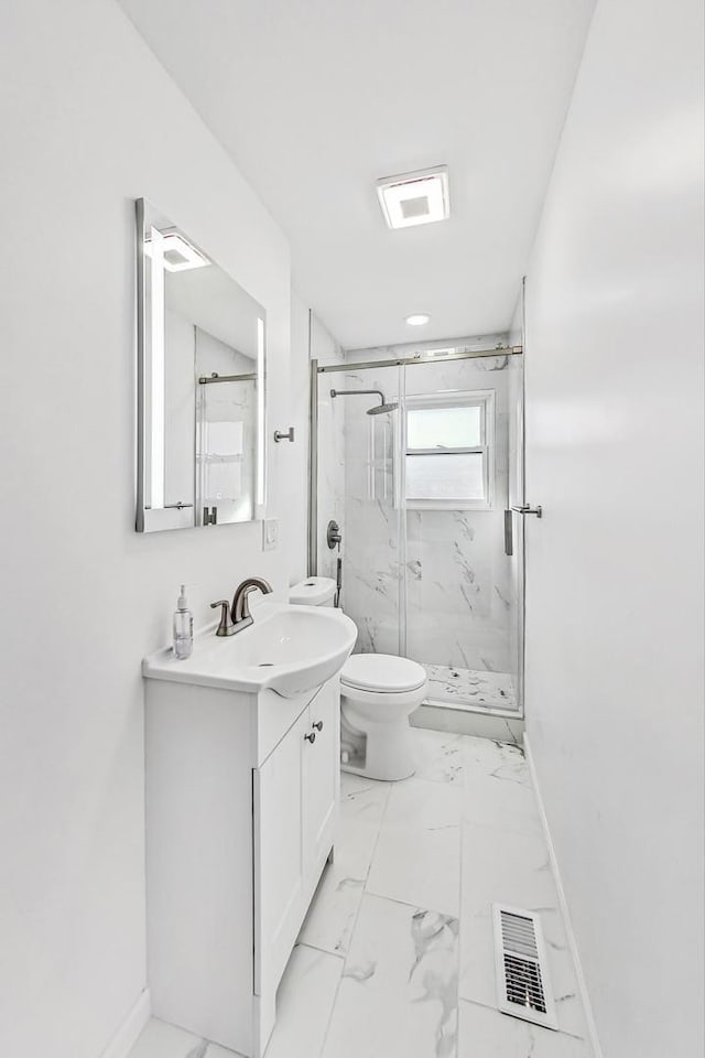 bathroom featuring walk in shower, vanity, and toilet