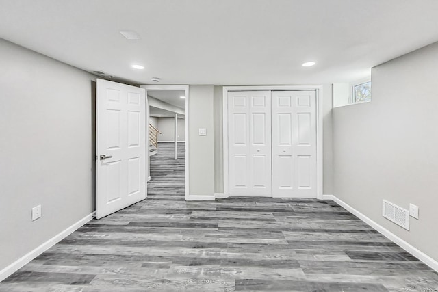 unfurnished bedroom featuring wood-type flooring and a closet