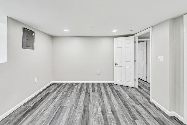 basement featuring electric panel and hardwood / wood-style floors