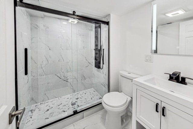 bathroom with vanity, toilet, and a shower with shower door