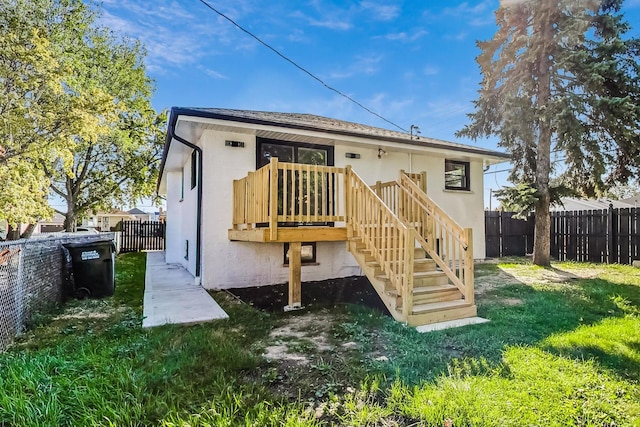 rear view of property with a yard