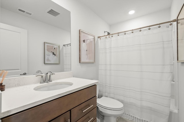 bathroom featuring toilet and vanity