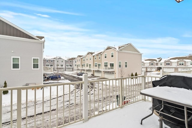 view of snow covered back of property