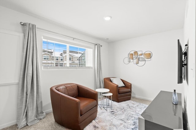 sitting room featuring light colored carpet