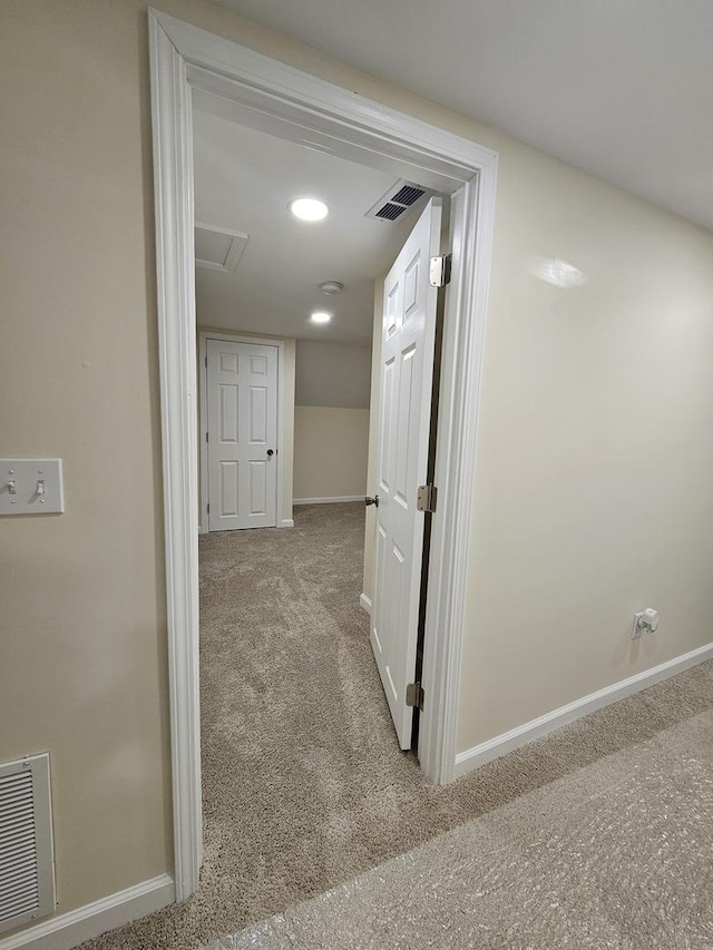 hallway with light colored carpet