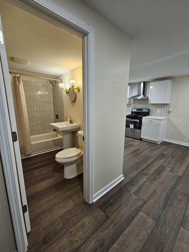 full bathroom with sink, shower / bath combo, tasteful backsplash, wood-type flooring, and toilet