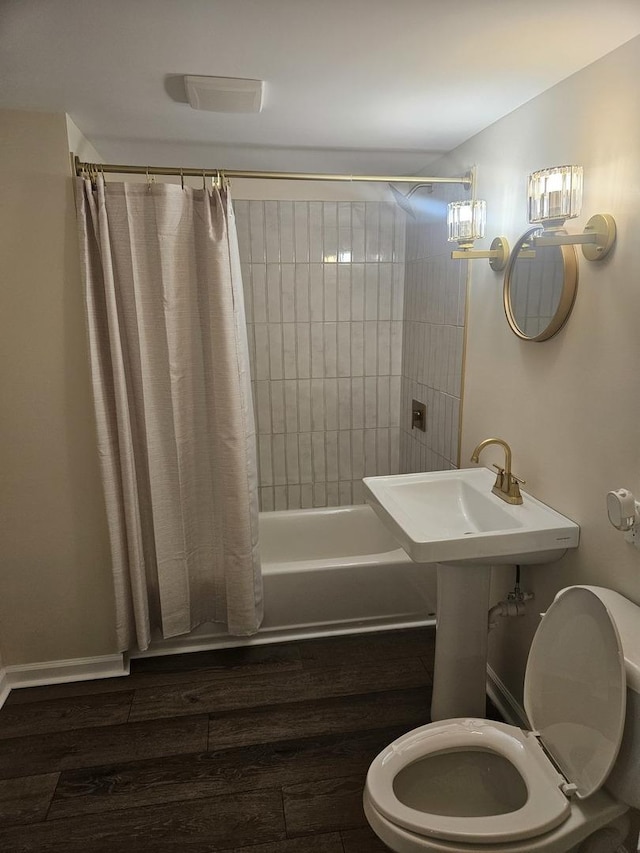 bathroom with toilet, shower / bathtub combination with curtain, and hardwood / wood-style floors