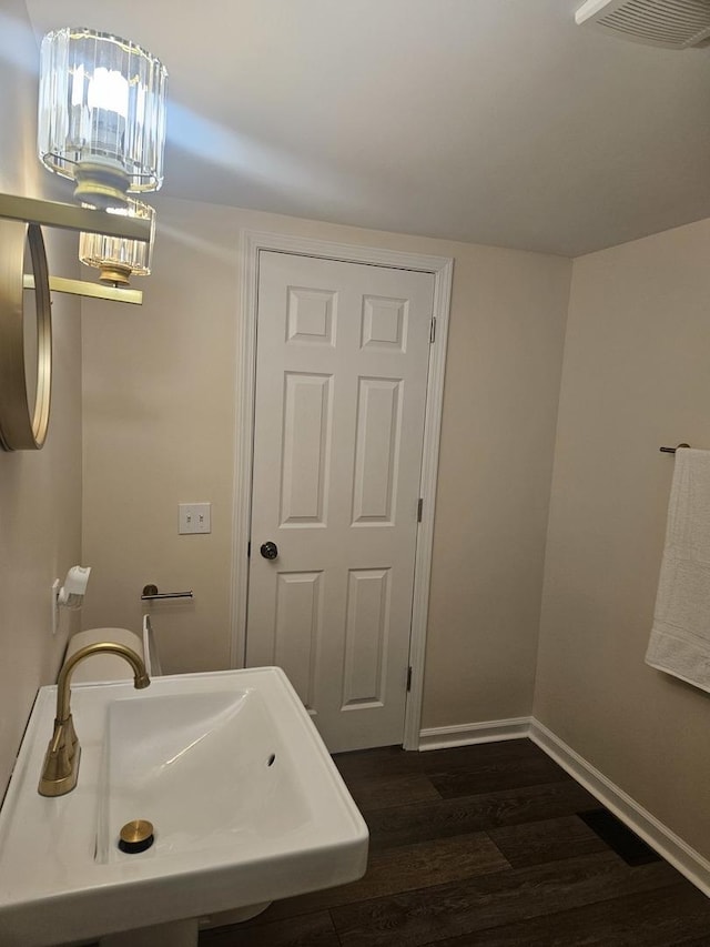 bathroom with wood-type flooring and sink