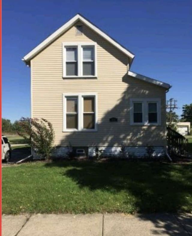 view of side of home featuring a yard