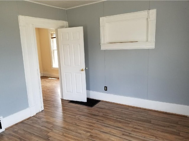 spare room featuring wood-type flooring