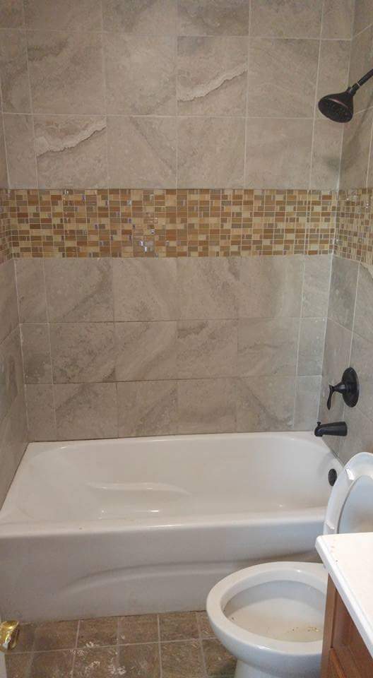 full bathroom featuring vanity, toilet, and tiled shower / bath combo